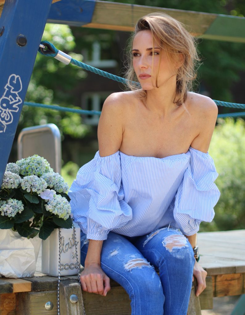 Alexandra Lapp wearing an off-the-shoulder blouse from Pixie Market, Chanel, Zara, IWC, Manolo Blahnik