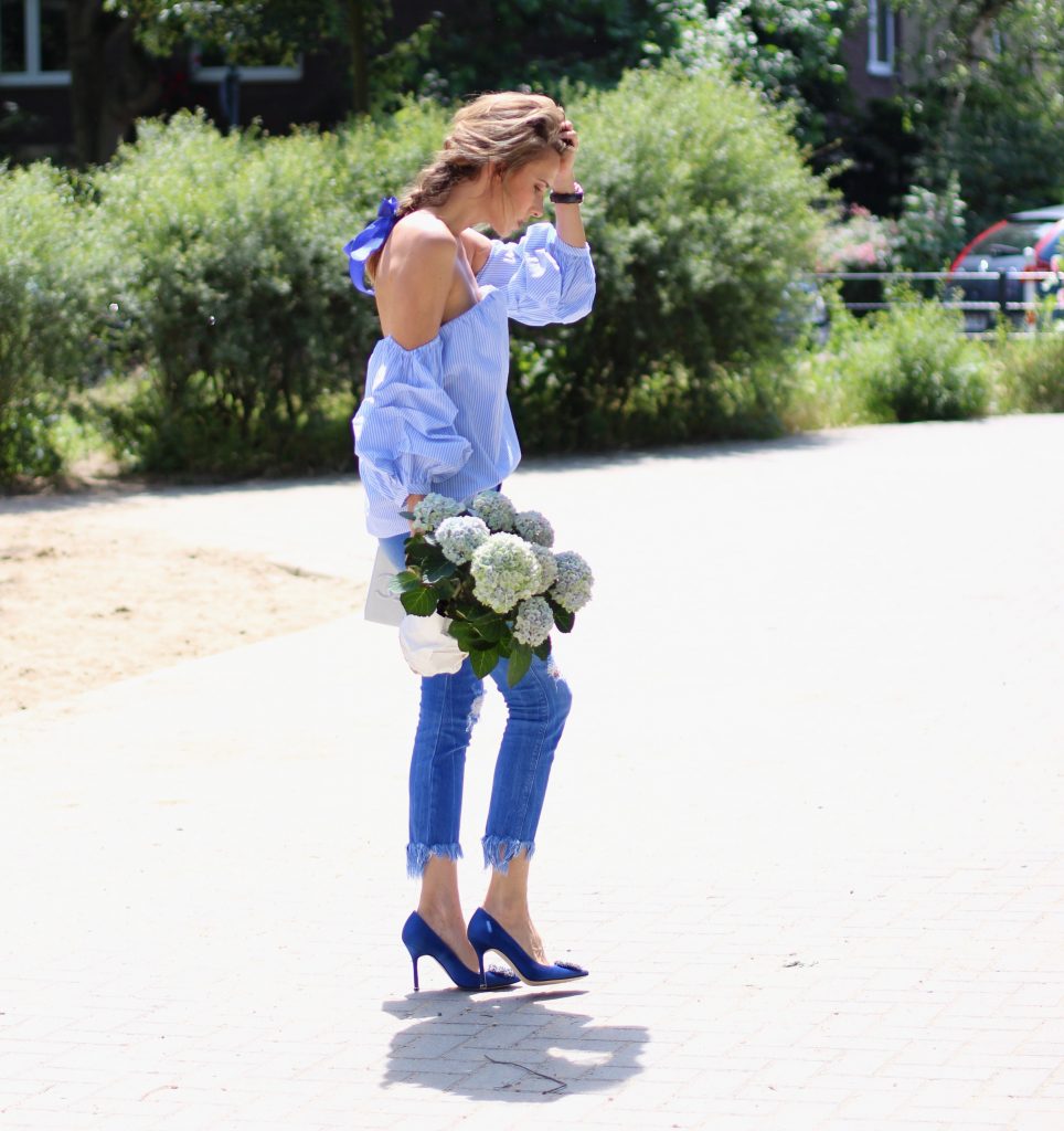 Alexandra Lapp wearing an off-the-shoulder blouse from Pixie Market, Chanel, Zara, IWC, Manolo Blahnik