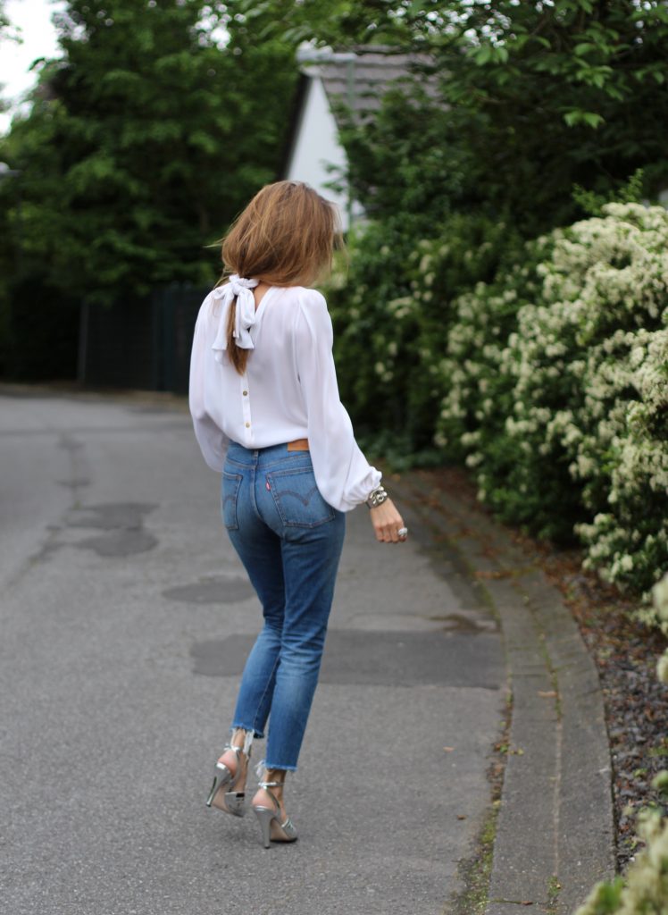 Emilio Pucci, Levi's, Miu Miu, Céline, Hermès Alexandra Lapp wearing a tie neck blouse from Emilio Pucci, Levi's, Miu Miu, Céline, Hermès