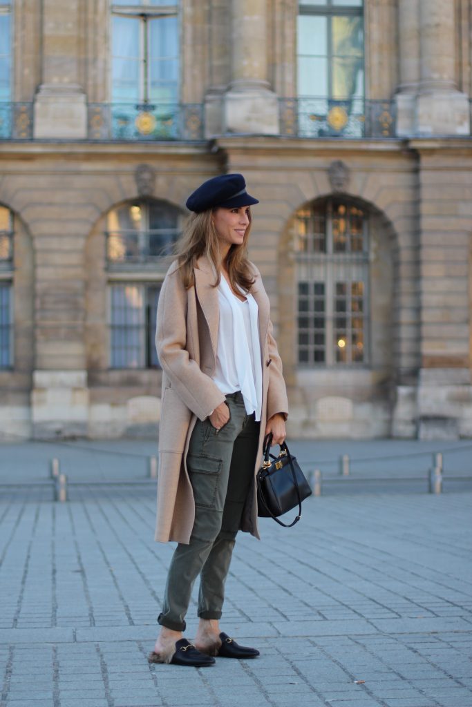 Place Vendôme, PARIS, FRANCE - NOVEMBER : German model and fashion blogger Alexandra Lapp (@alexandralapp_) wearing a camel coat, tie neck blouse and pants by Marc Aurel, princetown slippers from Gucci and peekaboo mini bag from Fendi, on November 2016 in Paris, France. *** Local Caption *** Alexandra Lapp