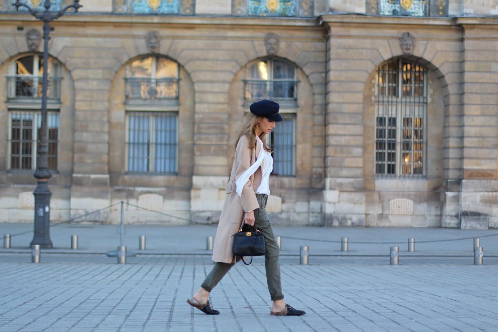 Place Vendôme, PARIS, FRANCE - NOVEMBER : German model and fashion blogger Alexandra Lapp (@alexandralapp_) wearing a camel coat, tie neck blouse and pants by Marc Aurel, princetown slippers from Gucci and peekaboo mini bag from Fendi, on November 2016 in Paris, France. *** Local Caption *** Alexandra Lapp