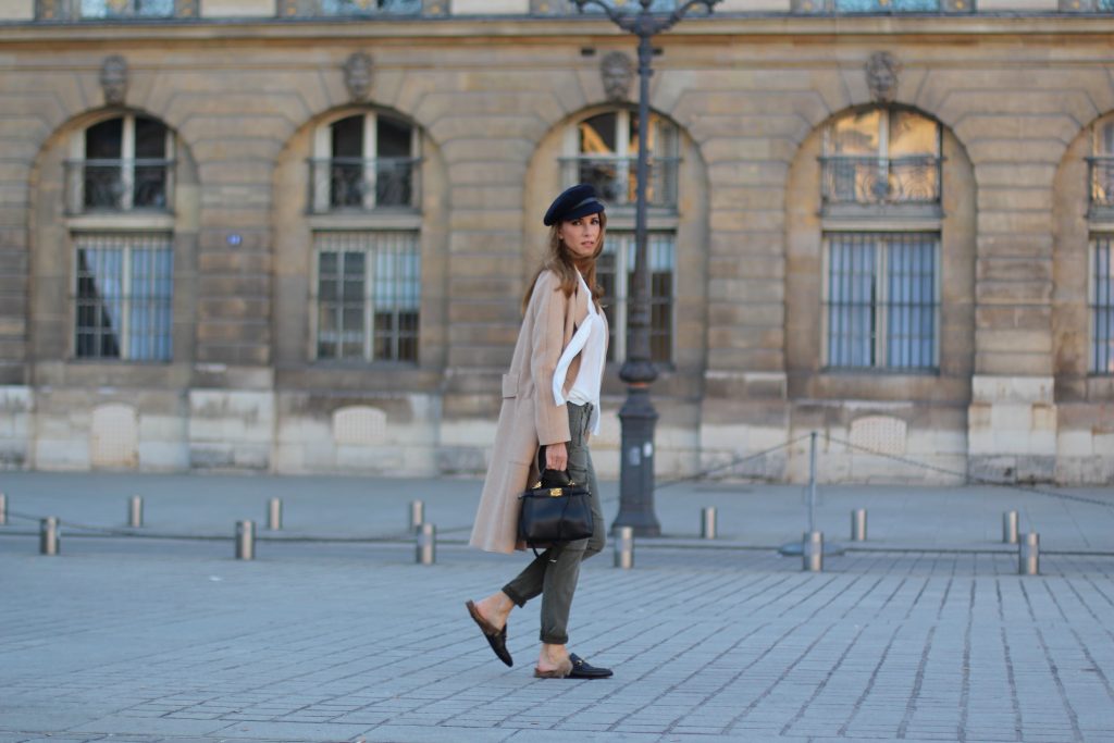 Place Vendôme, PARIS, FRANCE - NOVEMBER : German model and fashion blogger Alexandra Lapp (@alexandralapp_) wearing a camel coat, tie neck blouse and pants by Marc Aurel, princetown slippers from Gucci and peekaboo mini bag from Fendi, on November 2016 in Paris, France. *** Local Caption *** Alexandra Lapp