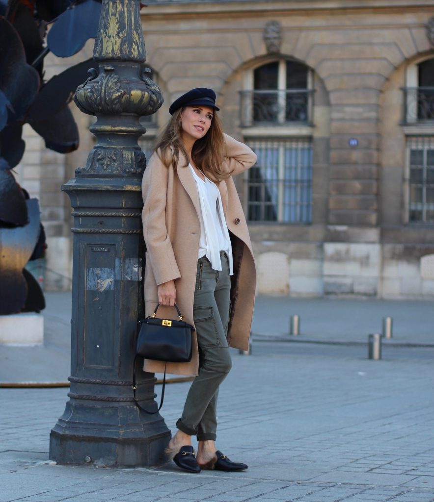 Place Vendôme, PARIS, FRANCE - NOVEMBER : German model and fashion blogger Alexandra Lapp (@alexandralapp_) wearing a camel coat, tie neck blouse and pants by Marc Aurel, princetown slippers from Gucci and peekaboo mini bag from Fendi, on November 2016 in Paris, France. *** Local Caption *** Alexandra Lapp