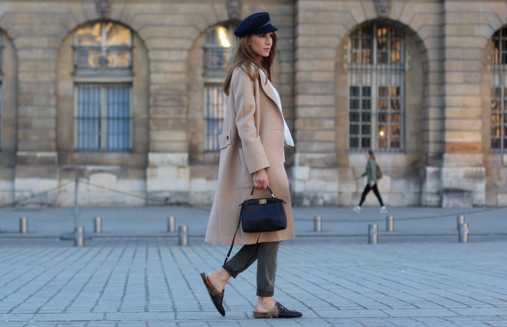 Place Vendôme, PARIS, FRANCE - NOVEMBER : German model and fashion blogger Alexandra Lapp (@alexandralapp_) wearing a camel coat, tie neck blouse and pants by Marc Aurel, princetown slippers from Gucci and peekaboo mini bag from Fendi, on November 2016 in Paris, France. *** Local Caption *** Alexandra Lapp
