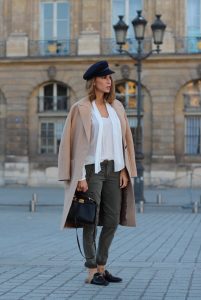 Place Vendôme, PARIS, FRANCE - NOVEMBER : German model and fashion blogger Alexandra Lapp (@alexandralapp_) wearing a camel coat, tie neck blouse and pants by Marc Aurel, princetown slippers from Gucci and peekaboo mini bag from Fendi, on November 2016 in Paris, France. *** Local Caption *** Alexandra Lapp