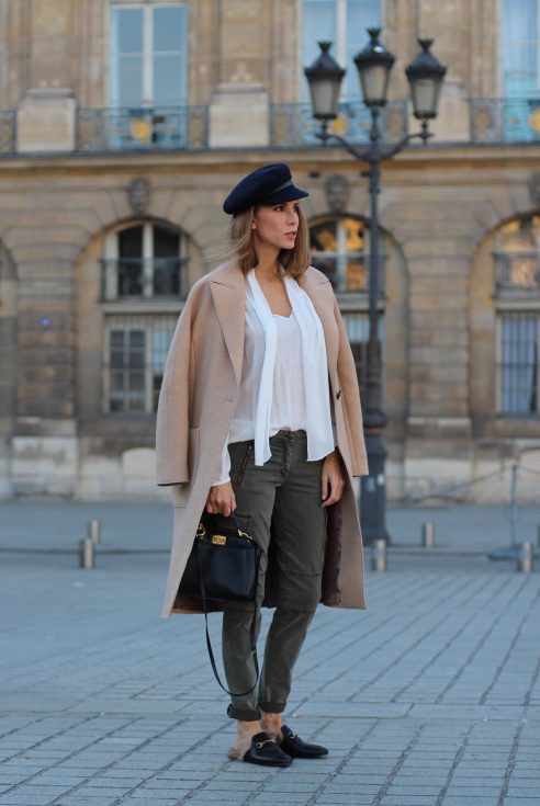 Place Vendôme, PARIS, FRANCE - NOVEMBER : German model and fashion blogger Alexandra Lapp (@alexandralapp_) wearing a camel coat, tie neck blouse and pants by Marc Aurel, princetown slippers from Gucci and peekaboo mini bag from Fendi, on November 2016 in Paris, France. *** Local Caption *** Alexandra Lapp