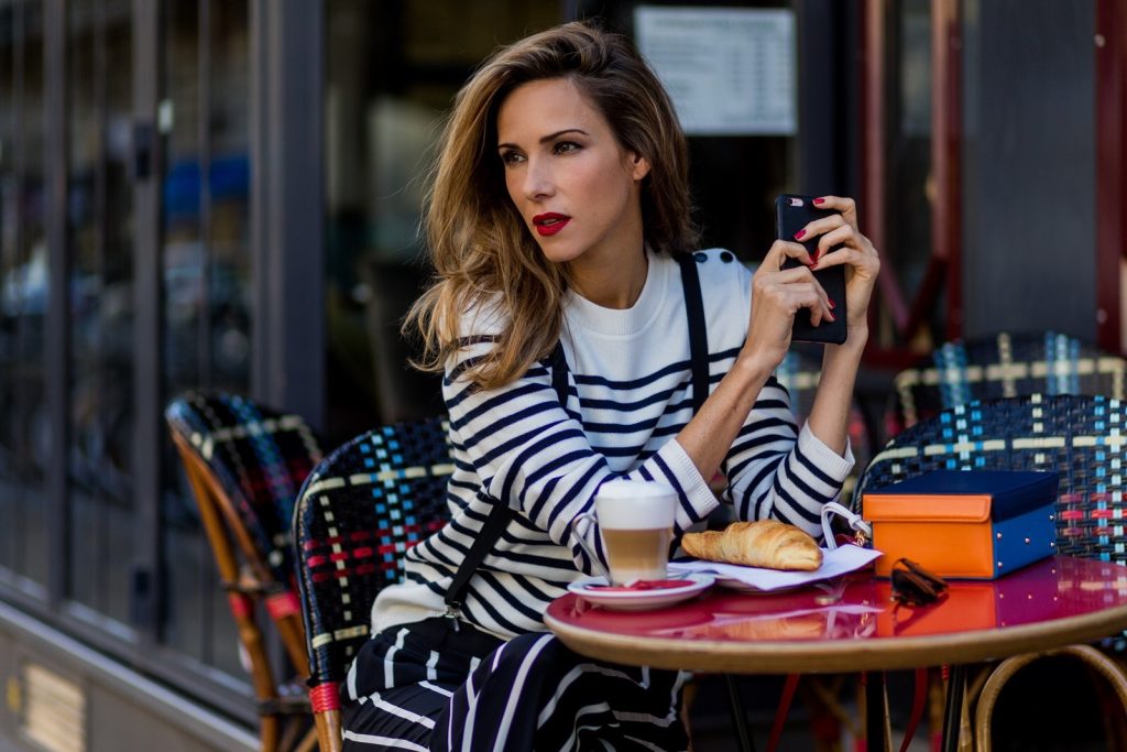 Steffen Schraut, Emilio Pucci, H&M, Gianvito Rossi, Mark Cross PARIS, FRANCE - OCTOBER 01: German model and fashion blogger Alexandra Lapp (@alexandralapp_) sitting in a French Cafe drinking coffee and eating Croissant wearing striped jumper from Steffen Schraut, striped pants from Emilio Pucci, suspenders H&M, Gianvito Rossi shoes and Mark Cross bag on October 1, 2016 in Paris, France. (Photo by Christian Vierig/Getty Images) *** Local Caption *** Alexandra Lapp