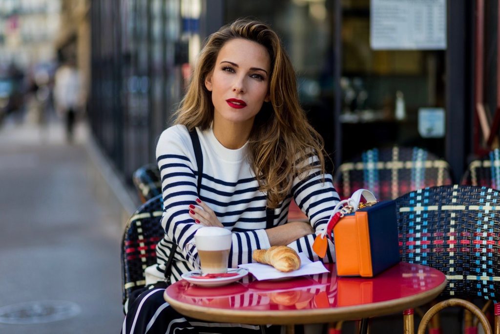 Steffen Schraut, Emilio Pucci, H&M, Gianvito Rossi, Mark Cross PARIS, FRANCE - OCTOBER 01: German model and fashion blogger Alexandra Lapp (@alexandralapp_) sitting in a French Cafe drinking coffee and eating Croissant wearing striped jumper from Steffen Schraut, striped pants from Emilio Pucci, suspenders H&M, Gianvito Rossi shoes and Mark Cross bag on October 1, 2016 in Paris, France. (Photo by Christian Vierig/Getty Images) *** Local Caption *** Alexandra Lapp