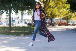PARIS, FRANCE - OCTOBER 03: German fashion blogger and model Alexandra Lapp (@alexandralapp_) wearing layer love, Levis denim jeans, a white James Perse tshirt, L'Agence plaid dress, white Zara shoes, Ray Ban sunglasses, Schott NYC leather jacket, Chanel bag on October 3, 2016 in Paris, France. (Photo by Christian Vierig/Getty Images) *** Local Caption *** Alexandra Lapp