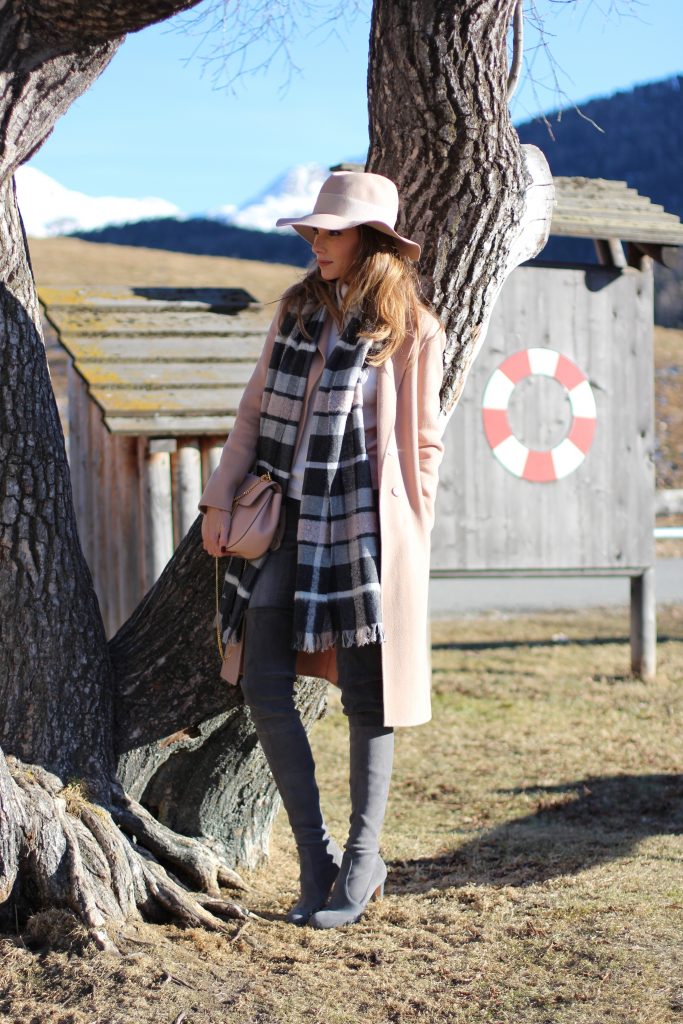 Sankt Moritz, Marc Cain, Gianvito Rossi, Chloé, IWC SANKT MORITZ - DEZEMBER : German model and fashion blogger Alexandra Lapp (@alexandralapp_) wearing Marc Cain in St. Moritz, an off white turtleneck, grey slim jeans, a beige cashmere coat, scarf and hat by Marc Cain, overknee boots in grey from Gianvito Rossi, IWC watch and a bag by Chloe on Dezember, 2016 in Sankt Moritz *** Local Caption *** Alexandra Lapp