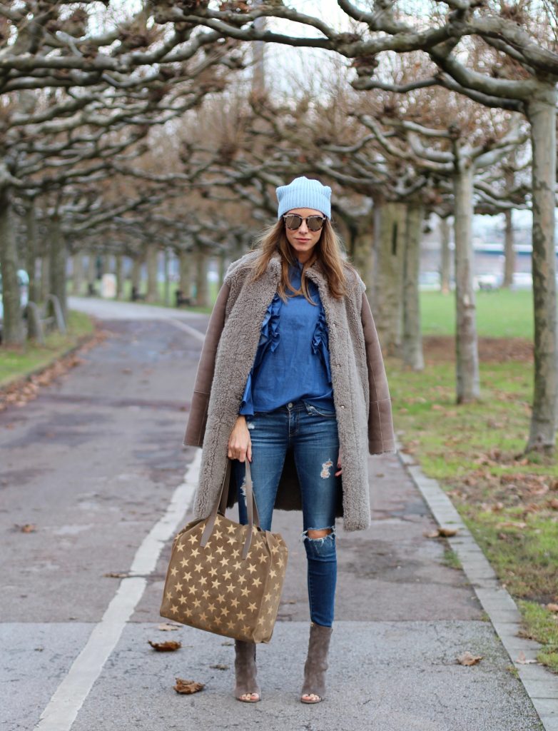 DÜSSELDORF; GERMANY - DEZEMBER : German model and fashion blogger Alexandra Lapp (@alexandralapp_) wearing denim on denim, a denim blouse from Storets, denim by Adriano Goldschmied, velvet booties by Halston, a baby blue beanie from Marc Cain, sunglasses by Le Specs, coat and bag by Steffen Schraut on Dezember, 2016 in Germany*** Local Caption *** Alexandra Lapp
