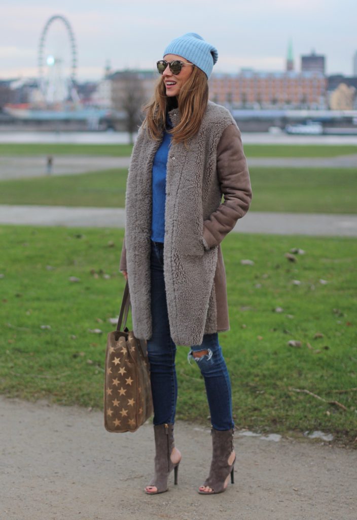 DÜSSELDORF; GERMANY - DEZEMBER : German model and fashion blogger Alexandra Lapp (@alexandralapp_) wearing denim on denim, a denim blouse from Storets, denim by Adriano Goldschmied, velvet booties by Halston, a baby blue beanie from Marc Cain, sunglasses by Le Specs, coat and bag by Steffen Schraut on Dezember, 2016 in Germany*** Local Caption *** Alexandra Lapp