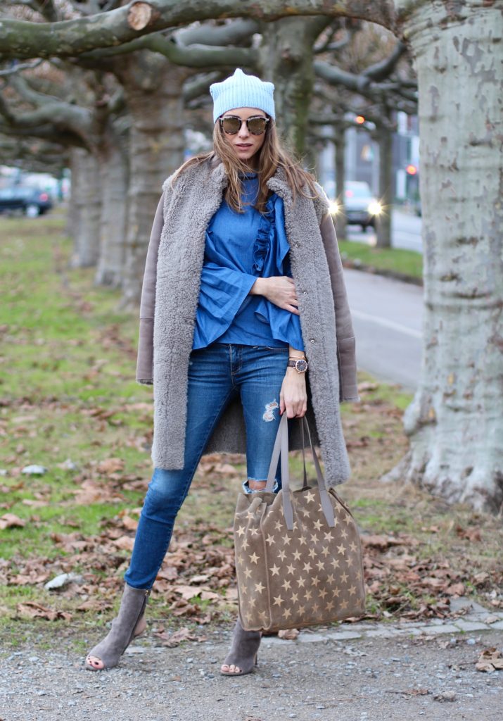 DÜSSELDORF; GERMANY - DEZEMBER : German model and fashion blogger Alexandra Lapp (@alexandralapp_) wearing denim on denim, a denim blouse from Storets, denim by Adriano Goldschmied, velvet booties by Halston, a baby blue beanie from Marc Cain, sunglasses by Le Specs, coat and bag by Steffen Schraut on Dezember, 2016 in Germany*** Local Caption *** Alexandra Lapp