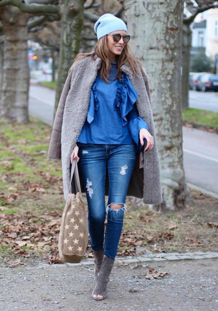 DÜSSELDORF; GERMANY - DEZEMBER : German model and fashion blogger Alexandra Lapp (@alexandralapp_) wearing denim on denim, a denim blouse from Storets, denim by Adriano Goldschmied, velvet booties by Halston, a baby blue beanie from Marc Cain, sunglasses by Le Specs, coat and bag by Steffen Schraut on Dezember, 2016 in Germany*** Local Caption *** Alexandra Lapp