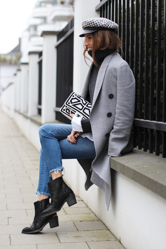 DÜSSELDORF; GERMANY - JANUARY : German model and fashion blogger Alexandra Lapp (@alexandralapp_) wearing western boots from Nubikk, high waist denim from Levi's, a white shirt and a grey cashmere coat by Céline, black and white bag from Chanel, hat from Eugenia Kim and cashmere knitwear by Loro Piana on January, 2017 in Germany*** Local Caption *** Alexandra Lapp