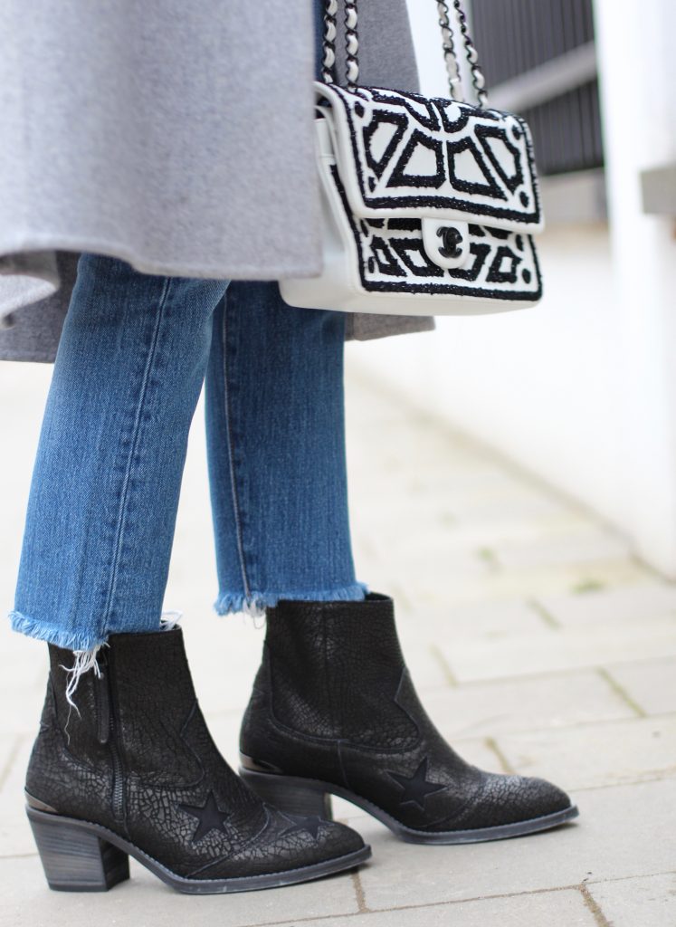 DÜSSELDORF; GERMANY - JANUARY : German model and fashion blogger Alexandra Lapp (@alexandralapp_) wearing western boots from Nubikk, high waist denim from Levi's, a white shirt and a grey cashmere coat by Céline, black and white bag from Chanel, hat from Eugenia Kim and cashmere knitwear by Loro Piana on January, 2017 in Germany*** Local Caption *** Alexandra Lapp