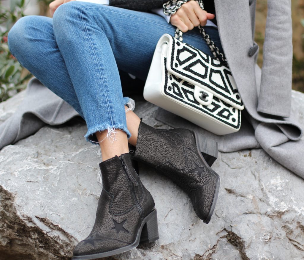 DÜSSELDORF; GERMANY - JANUARY : German model and fashion blogger Alexandra Lapp (@alexandralapp_) wearing western boots from Nubikk, high waist denim from Levi's, a white shirt and a grey cashmere coat by Céline, black and white bag from Chanel, hat from Eugenia Kim and cashmere knitwear by Loro Piana on January, 2017 in Germany*** Local Caption *** Alexandra Lapp