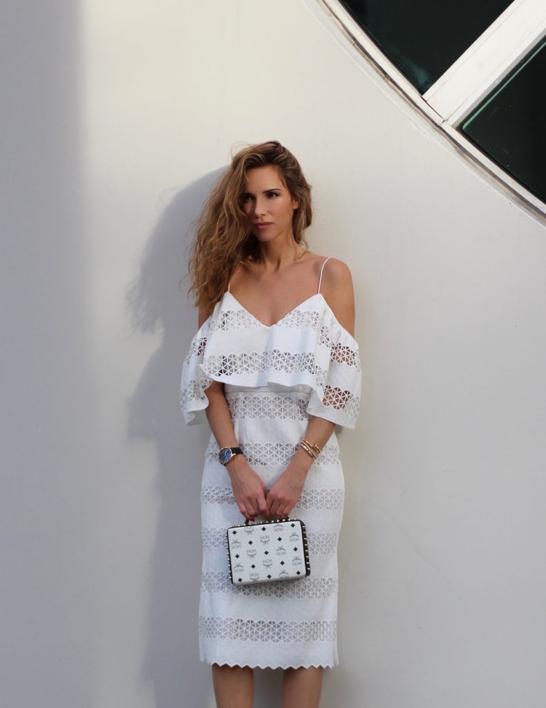 MIAMI; FLORIDA - JANUARY : German model and fashion blogger Alexandra Lapp (@alexandralapp_) wearing a MCM Berlin crossbody bag in black and white, Isla off the shoulder dress in white, Saint Laurent pumps, an IWC watch and cat eye sunglasses by Prada on January, 2017 in Miami *** Local Caption *** Alexandra Lapp