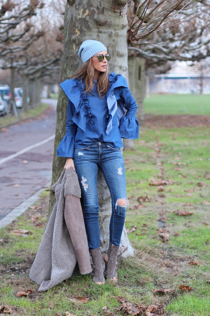 DÜSSELDORF; GERMANY - DEZEMBER : German model and fashion blogger Alexandra Lapp (@alexandralapp_) wearing denim on denim, a denim blouse from Storets, denim by Adriano Goldschmied, velvet booties by Halston, a baby blue beanie from Marc Cain, sunglasses by Le Specs, coat and bag by Steffen Schraut on Dezember, 2016 in Germany*** Local Caption *** Alexandra Lapp