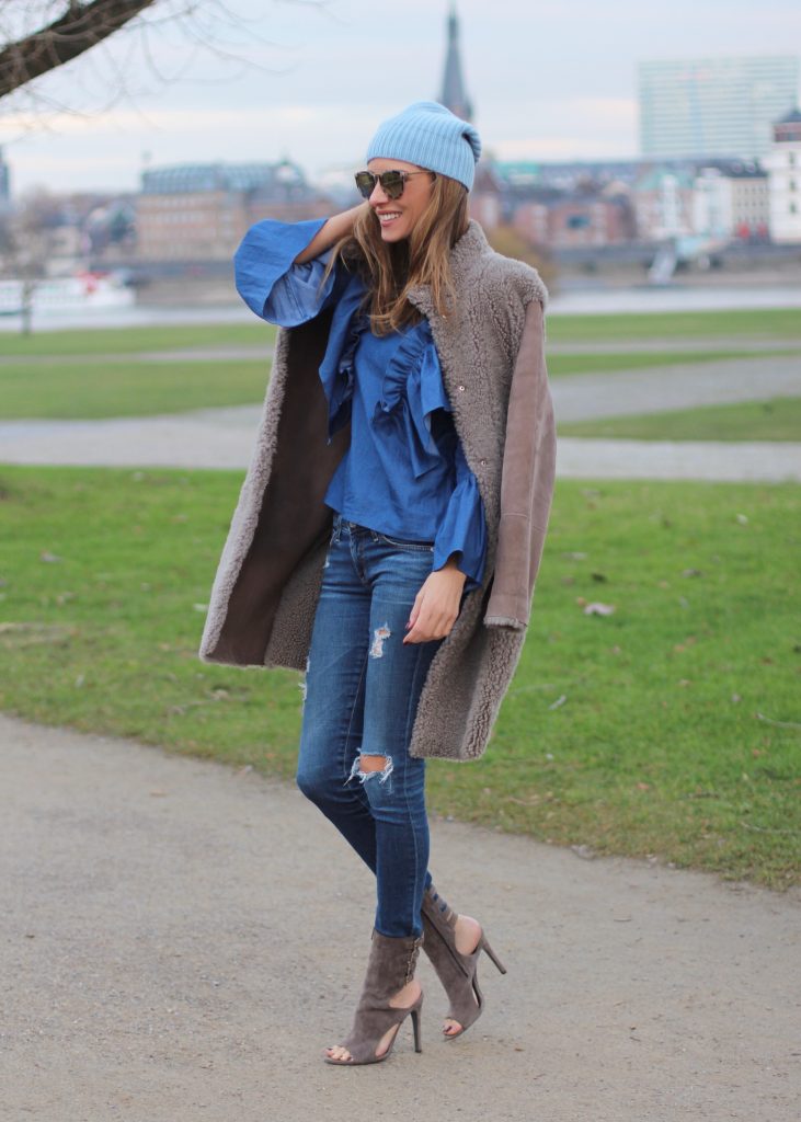 DÜSSELDORF; GERMANY - DEZEMBER : German model and fashion blogger Alexandra Lapp (@alexandralapp_) wearing denim on denim, a denim blouse from Storets, denim by Adriano Goldschmied, velvet booties by Halston, a baby blue beanie from Marc Cain, sunglasses by Le Specs, coat and bag by Steffen Schraut on Dezember, 2016 in Germany*** Local Caption *** Alexandra Lapp