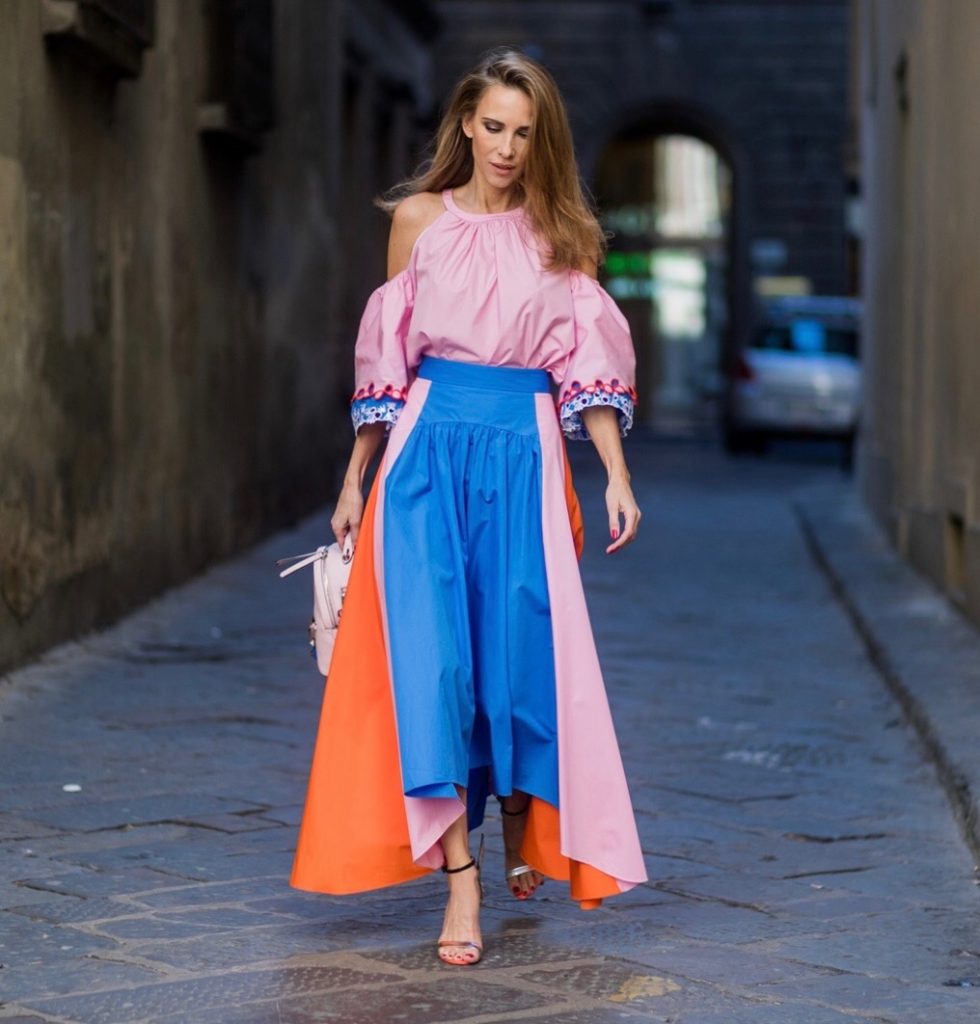 FLORENCE, ITALY - JANUARY 11: German fashion blogger and model Alexandra Lapp is wearing off-the-shoulder embroidered cotton-poplin blouse by Peter Pilotto, asymmetric cotton-poplin skirt by Peter Pilotto (this skirt is made from panels of bright-blue, baby-pink and bright-orange cotton-poplin and is cut with an asymmetric midi hem), Fendi baby pink leather shoulder bag embellished with colorful pyramid studs and adjustable shoulder strap, ‘Chiara’ Butterfly style sandals from Sophia Webster ( printed Butterfly Wing sandal, finished with a silver mirror front strap) on January 11, 2017 in Florence, Italy. (Photo by Christian Vierig/Getty Images) *** Local Caption *** Alexandra Lapp