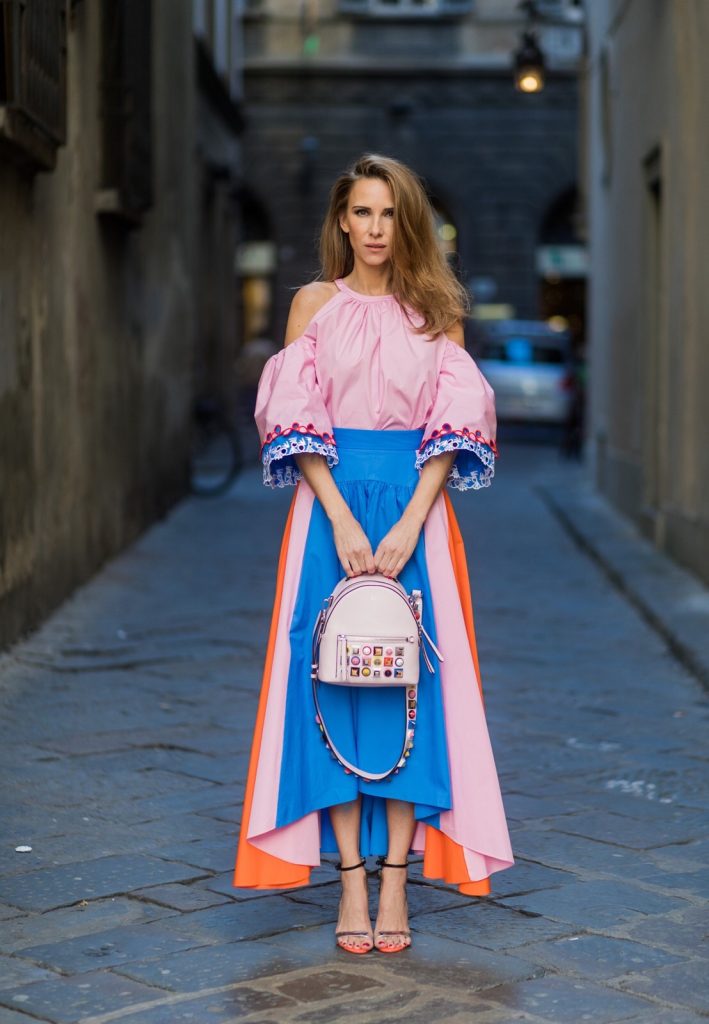 FLORENCE, ITALY - JANUARY 11: German fashion blogger and model Alexandra Lapp is wearing off-the-shoulder embroidered cotton-poplin blouse by Peter Pilotto, asymmetric cotton-poplin skirt by Peter Pilotto (this skirt is made from panels of bright-blue, baby-pink and bright-orange cotton-poplin and is cut with an asymmetric midi hem), Fendi baby pink leather shoulder bag embellished with colorful pyramid studs and adjustable shoulder strap, ‘Chiara’ Butterfly style sandals from Sophia Webster ( printed Butterfly Wing sandal, finished with a silver mirror front strap) on January 11, 2017 in Florence, Italy. (Photo by Christian Vierig/Getty Images) *** Local Caption *** Alexandra Lapp