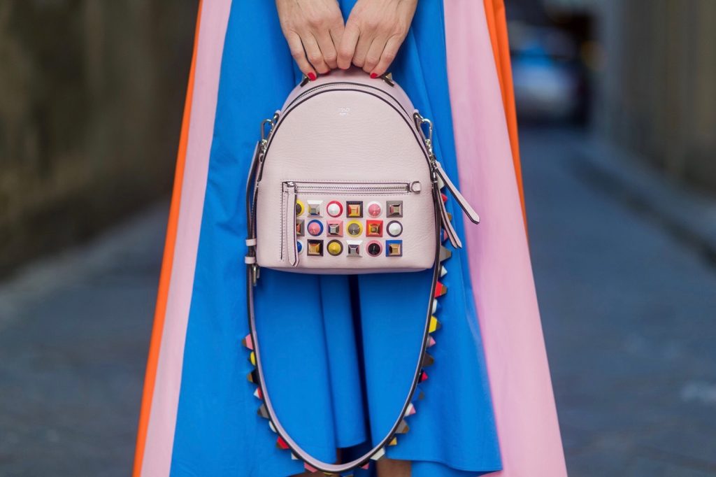 FLORENCE, ITALY - JANUARY 11: German fashion blogger and model Alexandra Lapp is wearing off-the-shoulder embroidered cotton-poplin blouse by Peter Pilotto, asymmetric cotton-poplin skirt by Peter Pilotto (this skirt is made from panels of bright-blue, baby-pink and bright-orange cotton-poplin and is cut with an asymmetric midi hem), Fendi baby pink leather shoulder bag embellished with colorful pyramid studs and adjustable shoulder strap, ‘Chiara’ Butterfly style sandals from Sophia Webster ( printed Butterfly Wing sandal, finished with a silver mirror front strap) on January 11, 2017 in Florence, Italy. (Photo by Christian Vierig/Getty Images) *** Local Caption *** Alexandra Lapp