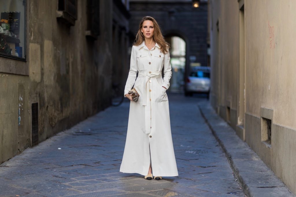 FLORENCE, ITALY - JANUARY 11: German fashion blogger and model Alexandra Lapp is wearing trenchcoat dress in white with golden buttons waisted with a belt from Talbot Runhof, Chanel mules and Chanel box clutch bag in gold (as seen on Carrie Bradshaw (Sarah Jessica Parker) in Sex and the City 2, sunglasses from Les Specs on January 11, 2017 in Florence, Italy. (Photo by Christian Vierig/Getty Images) *** Local Caption *** Alexandra Lapp