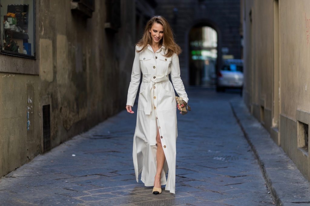 FLORENCE, ITALY - JANUARY 11: German fashion blogger and model Alexandra Lapp is wearing trenchcoat dress in white with golden buttons waisted with a belt from Talbot Runhof, Chanel mules and Chanel box clutch bag in gold (as seen on Carrie Bradshaw (Sarah Jessica Parker) in Sex and the City 2, sunglasses from Les Specs on January 11, 2017 in Florence, Italy. (Photo by Christian Vierig/Getty Images) *** Local Caption *** Alexandra Lapp