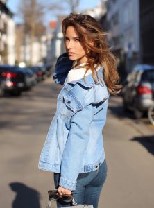 DÜSSELDORF, GERMANY - FEBRUARY 14: German fashion blogger and model Alexandra Lapp is wearing double denim - a light blue denim jacket by SET, slim fit high waist denim from Rag and Bone, off white knitwear from Oui, Hermes Kelly bag in light grey, Le Specs sunglasses, beige velvet booties from Gianvito Rossi and a light beige wool coat from Steffen Schraut on February 14, 2017 Düsseldorf, Germany. *** Local Caption *** Alexandra Lapp