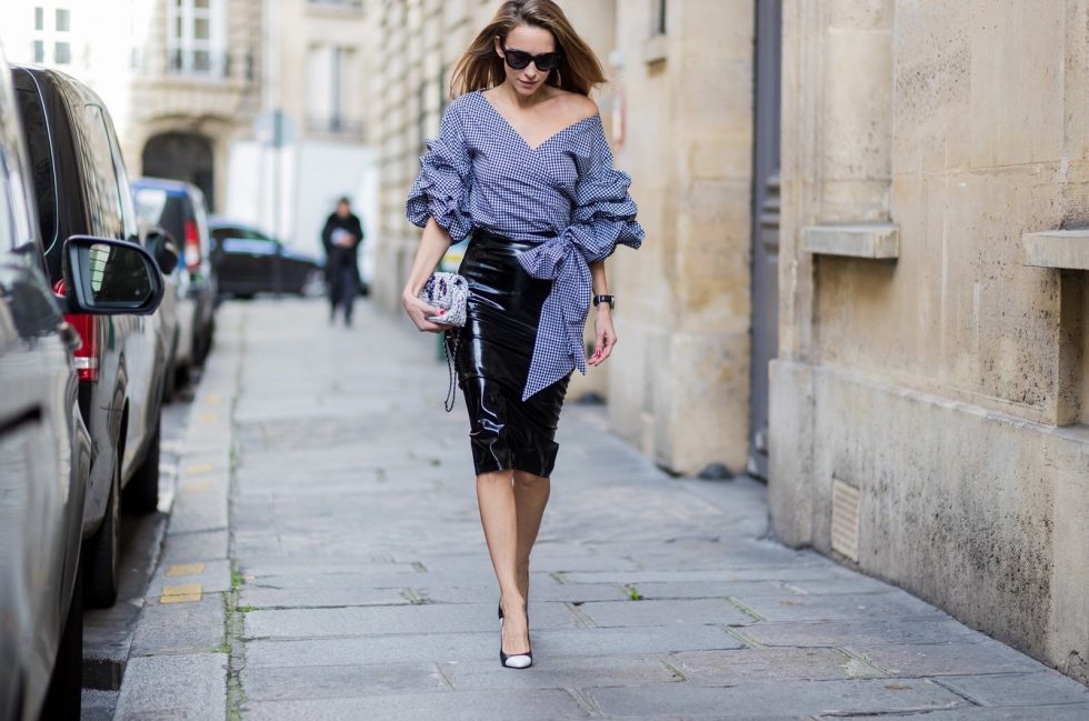 PARIS; FRANCE; Model and Blogger Alexandra Lapp wearing latex skirt and ruched sleeve top, a black Couture Latex Crystal pencil Skirt from Atsuko Kudo, Pepita blouse top from Storets with black and white check print, Decollete neckline and riches sleeve Black and white pumps from Saint Laurent, Oversized Audrey sunglasses from Celine, Black and white 2.55 bag in tweed from Chanel on March 3, 2017 in Paris, France.