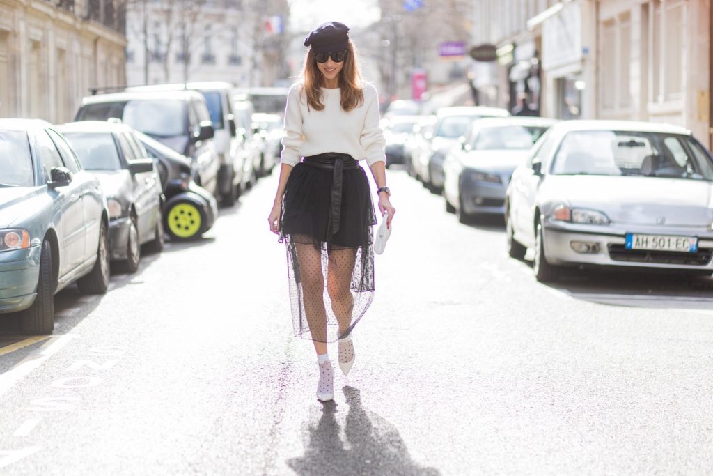 Rock Dots, PFW, PFW17, Paris, Storets, Chanel, Christian Louboutin, Oui Fashion, SET, IWC, Celine PARIS; FRANCE; Blogger and Model Alexandra Lapp rock dots by wearing knit Oui Black Lace Layer Skirt from Storets with layers of differently patterned sheer fabrics, a classic skater style silhouette with lace and dotted patterns cascading down below the leg, Leather waist belt - Set Fashion, Socks - vintage, Pumps - white snake pumps from Christan Louboutin, Sunglasses - Celine Audrey, Clutch - Chanel on March 3, 2017 in Paris, France.