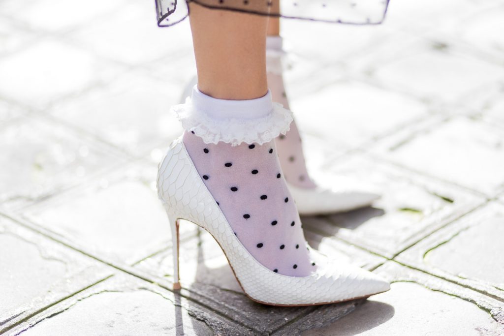 Rock Dots, PFW, PFW17, Paris, Storets, Chanel, Christian Louboutin, Oui Fashion, SET, IWC, Celine PARIS; FRANCE; Blogger and Model Alexandra Lapp rock dots by wearing knit Oui Black Lace Layer Skirt from Storets with layers of differently patterned sheer fabrics, a classic skater style silhouette with lace and dotted patterns cascading down below the leg, Leather waist belt - Set Fashion, Socks - vintage, Pumps - white snake pumps from Christan Louboutin, Sunglasses - Celine Audrey, Clutch - Chanel on March 3, 2017 in Paris, France.