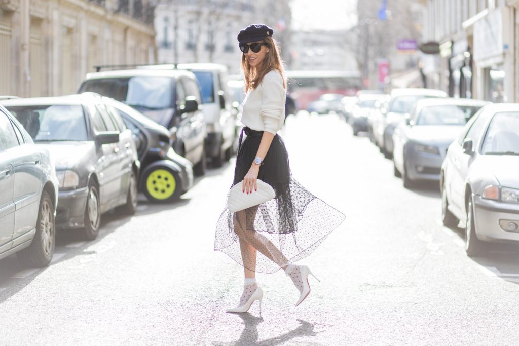 Rock Dots, PFW, PFW17, Paris, Storets, Chanel, Christian Louboutin, Oui Fashion, SET, IWC, Celine PARIS; FRANCE; Blogger and Model Alexandra Lapp rock dots by wearing knit Oui Black Lace Layer Skirt from Storets with layers of differently patterned sheer fabrics, a classic skater style silhouette with lace and dotted patterns cascading down below the leg, Leather waist belt - Set Fashion, Socks - vintage, Pumps - white snake pumps from Christan Louboutin, Sunglasses - Celine Audrey, Clutch - Chanel on March 3, 2017 in Paris, France.