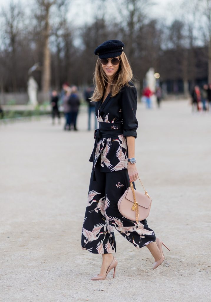 PARIS; FRANCE; during PFW, Model and Blogger Alexandra Lapp wearing Sleepwear to Daywear, Printed jacket with contrasting sash belt, lapel collar and long sleeves from Zara in black with rose birds, Matching flowing printed culottes from Zara in black with rose birds, Christian Louboutin nude lacquer pumps, nude Drew small leather cross-body bag by Chloe, Cap from Chanel, Sunglasses by Chloe on March 3, 2017 in Paris, France.
