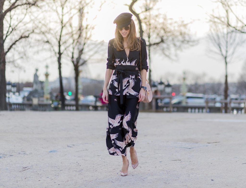 PARIS; FRANCE; during PFW, Model and Blogger Alexandra Lapp wearing Sleepwear to Daywear, Printed jacket with contrasting sash belt, lapel collar and long sleeves from Zara in black with rose birds, Matching flowing printed culottes from Zara in black with rose birds, Christian Louboutin nude lacquer pumps, nude Drew small leather cross-body bag by Chloe, Cap from Chanel, Sunglasses by Chloe on March 3, 2017 in Paris, France.