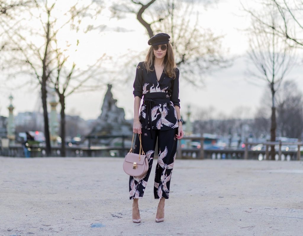 PARIS; FRANCE; during PFW, Model and Blogger Alexandra Lapp wearing Sleepwear to Daywear, Printed jacket with contrasting sash belt, lapel collar and long sleeves from Zara in black with rose birds, Matching flowing printed culottes from Zara in black with rose birds, Christian Louboutin nude lacquer pumps, nude Drew small leather cross-body bag by Chloe, Cap from Chanel, Sunglasses by Chloe on March 3, 2017 in Paris, France.