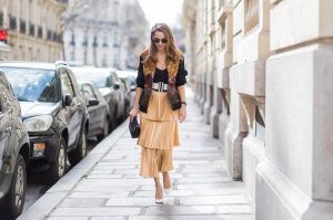 PARIS;FRANCE during PFW, Model and Blogger Alexandra Lapp wearing a pleated skirt & bomber jacket from Stella McCartney, skirt named Melody skirt, Stella McCartney blue Falabella box mini shoulder bag, black silk Tank top from Jadicted, white lacquer pumps by Prada, RayBan clubmaster sunglasses, waist belt in black and white by Balmain on March 3, 2017 in Paris, France.