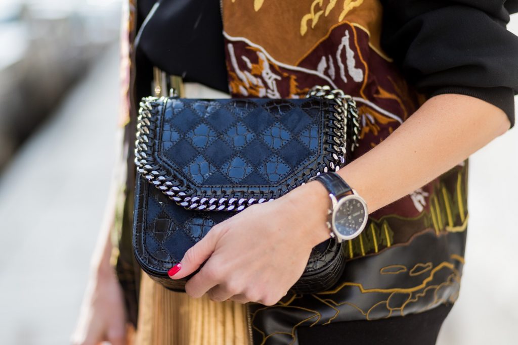 Paris, France, PFW, pleated skirt, bomber jacket, Stella McCartney, Jadicted, RayBan, Prada, IWC, Balmain PARIS;FRANCE during PFW, Model and Blogger Alexandra Lapp wearing a pleated skirt & bomber jacket from Stella McCartney, skirt named Melody skirt, Stella McCartney blue Falabella box mini shoulder bag, black silk Tank top from Jadicted, white lacquer pumps by Prada, RayBan clubmaster sunglasses, waist belt in black and white by Balmain on March 3, 2017 in Paris, France.