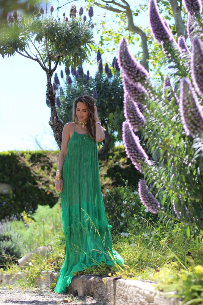 Los Angeles, MALIBU, April 2017, Model and Blogger Alexandra Lapp wearing Art Youth Society AYS jewelry, a green long JOY dress by Stella McCartney, bracelets from GAS Bijoux, a coin belt around the neck worn like a necklace and a IWC Da Vinci watch in red gold with diamonds in Malibu, Los Angeles, April 2017.
