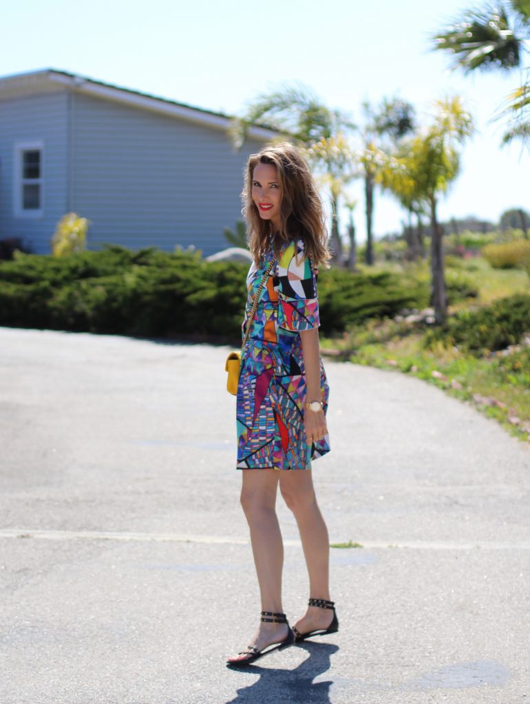 Malibu, Los Angeles; Model and fashion blogger Alexandra Lapp wearing a colorful dress by La Martina, the Polo brand, sandals from Saint Laurent in black with golden rock studs, red lipstick from MAC, a yellow Gucci GG Marmont bag, IWC Da Vinci Automatic 36 watch in 18-carat red gold with diamonds and jewelry from AYS (Art Youth Society) in Malibu on April 17, 2017 in Los Angeles, California.