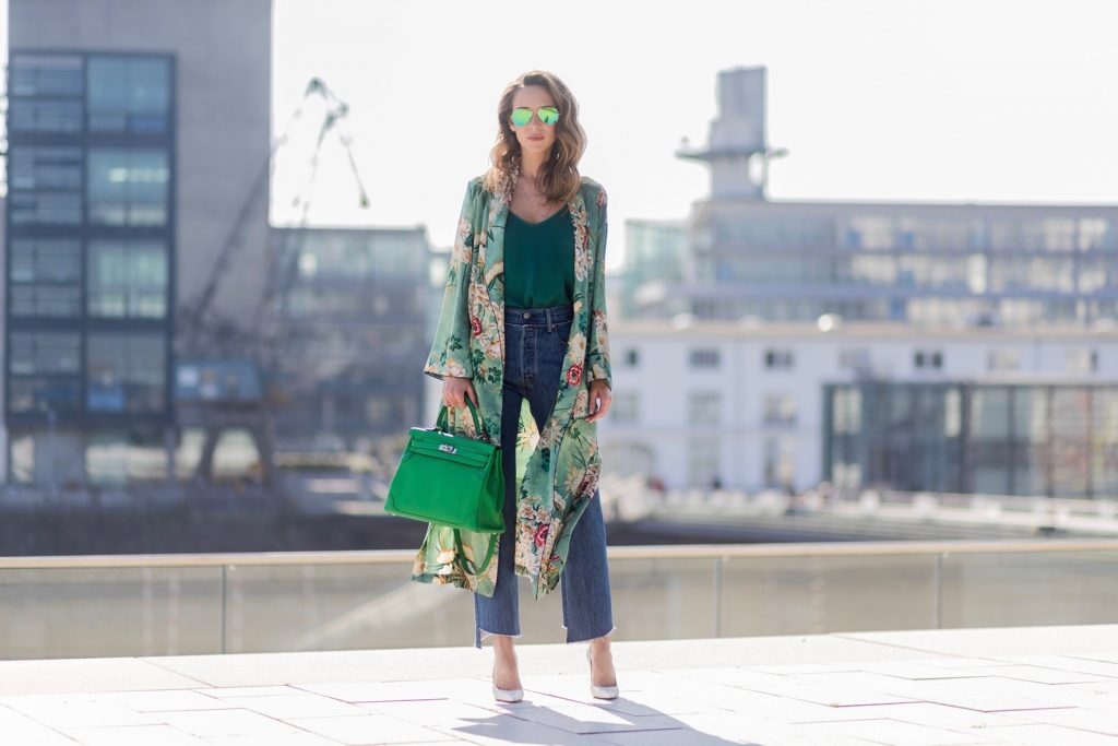Kimono Love, Zara, Vetements, Christian Louboutin, AYS, Jadicted, Hermes, Kelly bag, Ray Ban Model and fashion blogger Alexandra Lapp has a Kimono Love, wearing a green flower printed kimono from Zara, a green tank top in silk, blue jeans from Vetements in cooperation with Levi´s with cut-out raw hems, white snake pumps from Christian Louboutin, Ray Ban Aviator sunglasses in green and a Hermes Kelly Ghillies 35 bag in green bamboo on March 30, 2017 in Duesseldorf, Germany.