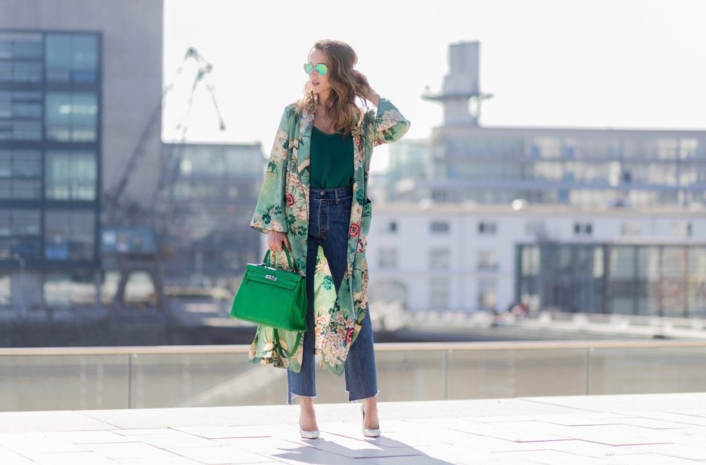 Kimono Love, Zara, Vetements, Christian Louboutin, AYS, Jadicted, Hermes, Kelly bag, Ray Ban Model and fashion blogger Alexandra Lapp has a Kimono Love, wearing a green flower printed kimono from Zara, a green tank top in silk, blue jeans from Vetements in cooperation with Levi´s with cut-out raw hems, white snake pumps from Christian Louboutin, Ray Ban Aviator sunglasses in green and a Hermes Kelly Ghillies 35 bag in green bamboo on March 30, 2017 in Duesseldorf, Germany.