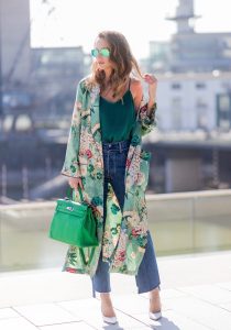 Model and fashion blogger Alexandra Lapp has a Kimono Love, wearing a green flower printed kimono from Zara, a green tank top in silk, blue jeans from Vetements in cooperation with LeviÂ´s with cut-out raw hems, white snake pumps from Christian Louboutin, Ray Ban Aviator sunglasses in green and a Hermes Kelly Ghillies 35 bag in green bamboo on March 30, 2017 in Duesseldorf, Germany.