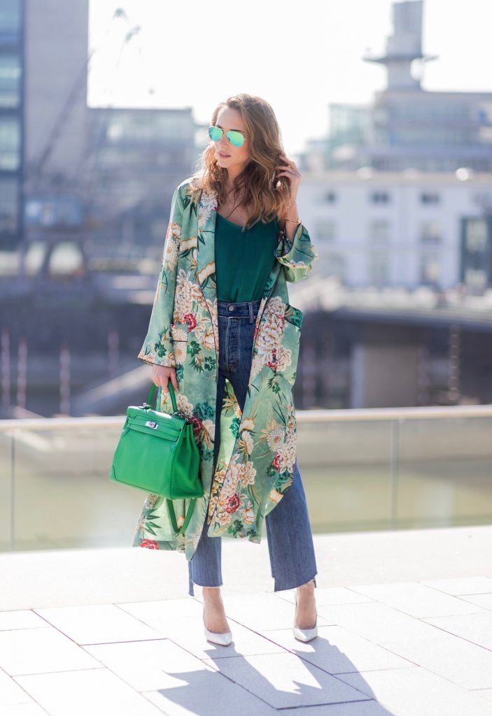 Kimono Love, Zara, Vetements, Christian Louboutin, AYS, Jadicted, Hermes, Kelly bag, Ray Ban Model and fashion blogger Alexandra Lapp has a Kimono Love, wearing a green flower printed kimono from Zara, a green tank top in silk, blue jeans from Vetements in cooperation with Levi´s with cut-out raw hems, white snake pumps from Christian Louboutin, Ray Ban Aviator sunglasses in green and a Hermes Kelly Ghillies 35 bag in green bamboo on March 30, 2017 in Duesseldorf, Germany.