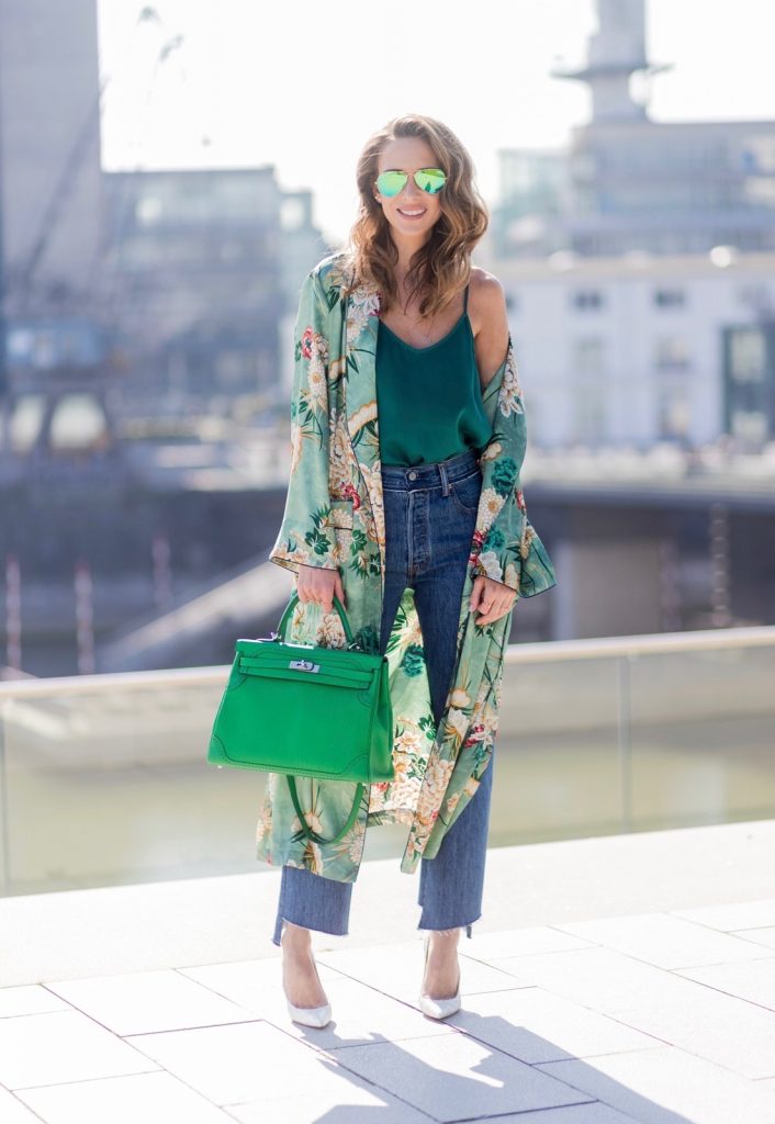 Kimono Love, Zara, Vetements, Christian Louboutin, AYS, Jadicted, Hermes, Kelly bag, Ray Ban Model and fashion blogger Alexandra Lapp has a Kimono Love, wearing a green flower printed kimono from Zara, a green tank top in silk, blue jeans from Vetements in cooperation with Levi´s with cut-out raw hems, white snake pumps from Christian Louboutin, Ray Ban Aviator sunglasses in green and a Hermes Kelly Ghillies 35 bag in green bamboo on March 30, 2017 in Duesseldorf, Germany.