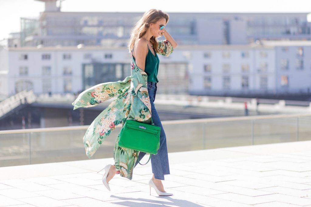 Kimono Love, Zara, Vetements, Christian Louboutin, AYS, Jadicted, Hermes, Kelly bag, Ray Ban Model and fashion blogger Alexandra Lapp has a Kimono Love, wearing a green flower printed kimono from Zara, a green tank top in silk, blue jeans from Vetements in cooperation with Levi´s with cut-out raw hems, white snake pumps from Christian Louboutin, Ray Ban Aviator sunglasses in green and a Hermes Kelly Ghillies 35 bag in green bamboo on March 30, 2017 in Duesseldorf, Germany.