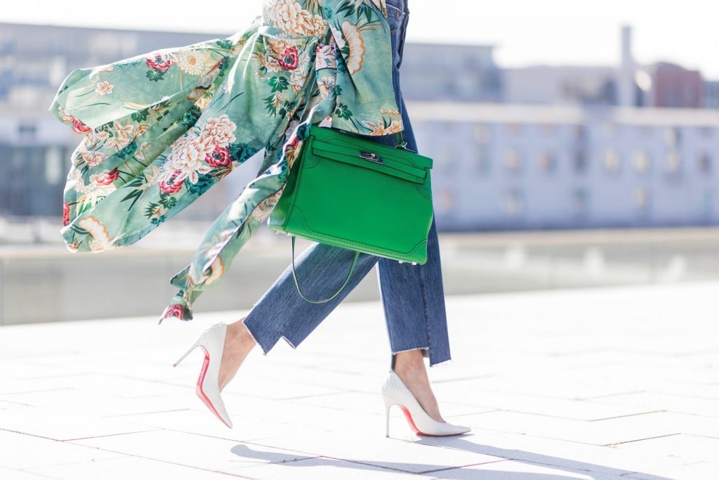 Kimono Love, Zara, Vetements, Christian Louboutin, AYS, Jadicted, Hermes, Kelly bag, Ray Ban Model and fashion blogger Alexandra Lapp has a Kimono Love, wearing a green flower printed kimono from Zara, a green tank top in silk, blue jeans from Vetements in cooperation with Levi´s with cut-out raw hems, white snake pumps from Christian Louboutin, Ray Ban Aviator sunglasses in green and a Hermes Kelly Ghillies 35 bag in green bamboo on March 30, 2017 in Duesseldorf, Germany.