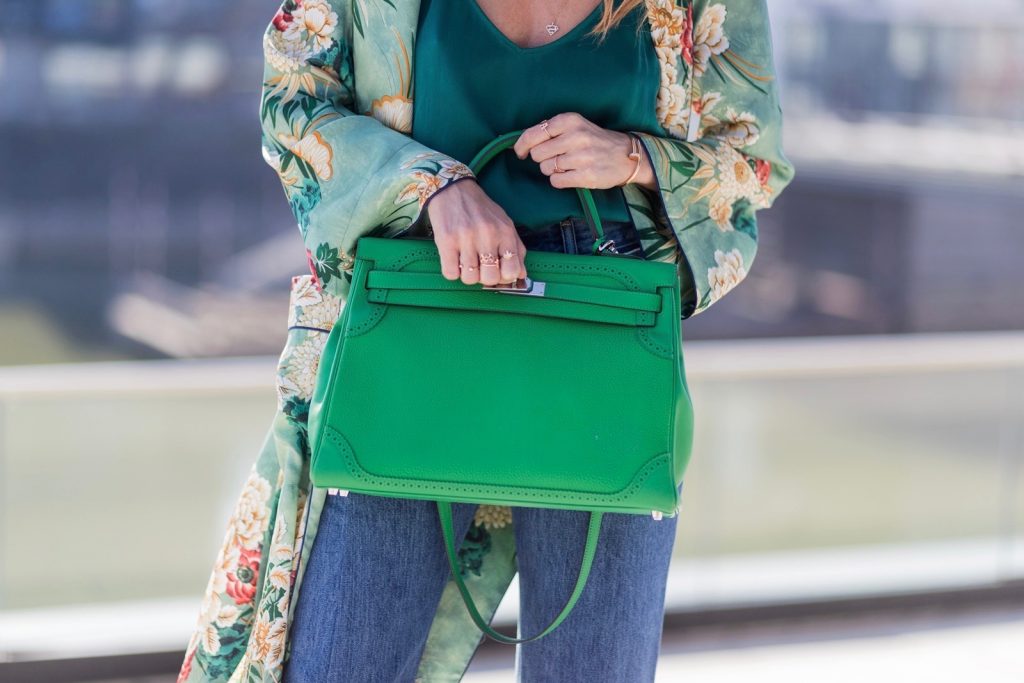 Kimono Love, Zara, Vetements, Christian Louboutin, AYS, Jadicted, Hermes, Kelly bag, Ray Ban Model and fashion blogger Alexandra Lapp has a Kimono Love, wearing a green flower printed kimono from Zara, a green tank top in silk, blue jeans from Vetements in cooperation with Levi´s with cut-out raw hems, white snake pumps from Christian Louboutin, Ray Ban Aviator sunglasses in green and a Hermes Kelly Ghillies 35 bag in green bamboo on March 30, 2017 in Duesseldorf, Germany.