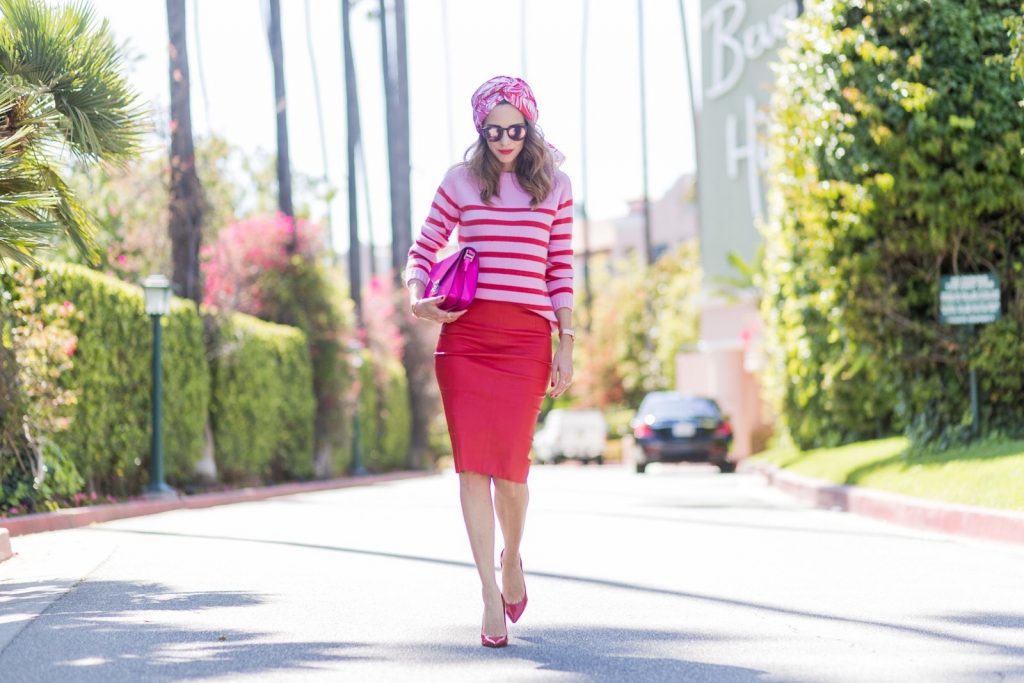 Bandana, MCM, American Retro, Heartbreaker, Le Specs, Gianvito Rossi, IWC Model and fashion blogger Alexandra Lapp wearing a scarf as a bandana from Heartbreaker, a red stretch leather pencil skirt from American Retro, pink and red striped cashmere pullover by Heartbreaker, red lacquer pumps from Gianvito Rossi, an electric-pink Patricia bag, a small crossbody in vachetta leather, complete with a well-organized interior lined in orange sueded nylon, sunglasses from Le Specs, IWC Da Vinci Automatic 36 watch in 18-carat red gold with diamonds and jewelry from AYS (Art Youth Society) on April 20, 2017 in Los Angeles, California.